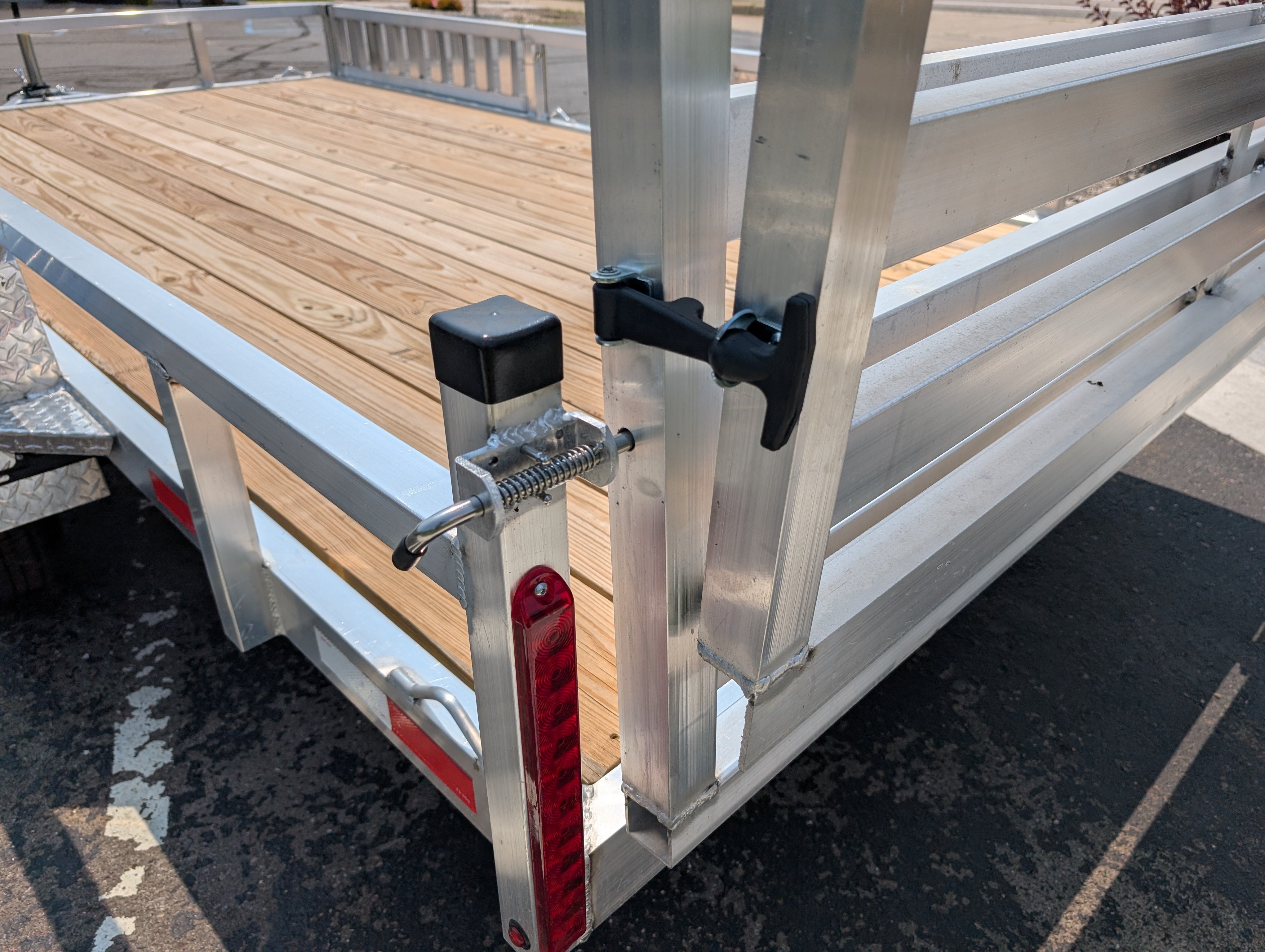 Silver Ox utility trailer ramp gate hinge and latch mechanism detail