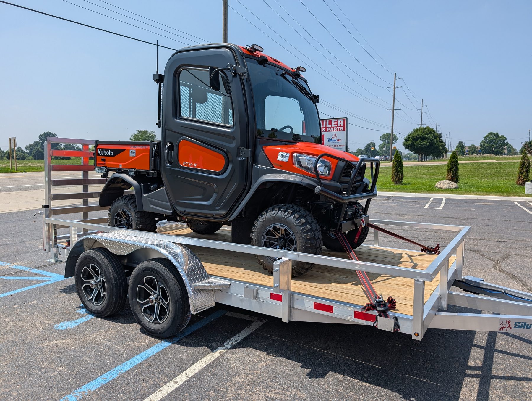 Silver Ox 7x14 tandem axle aluminum trailer with Kubota RTV-X side view