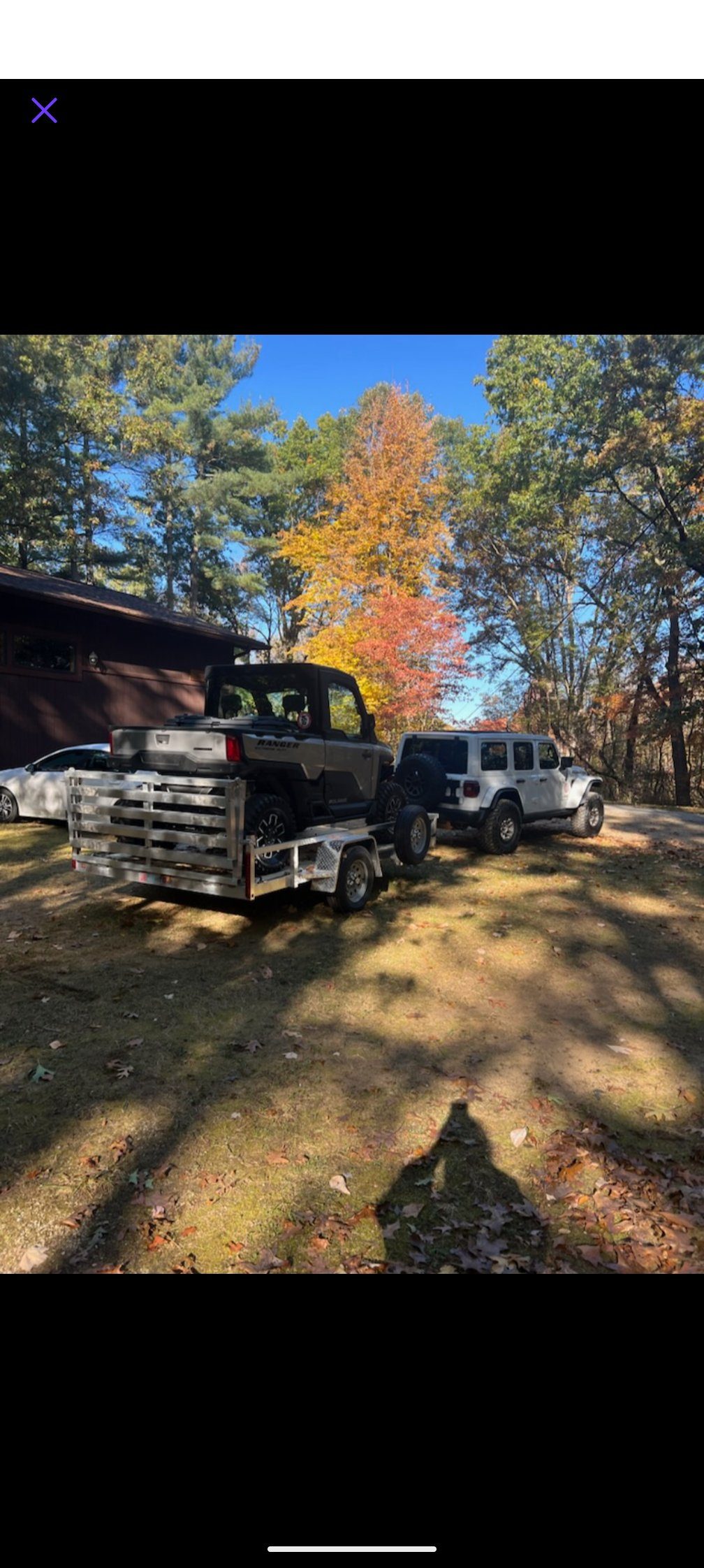 Silver Ox utility trailer hauling Polaris Ranger in Northern Michigan fall colors